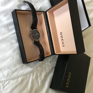 Black and silver Gucci watch with leather strap